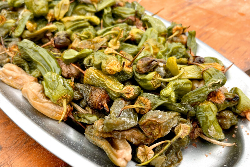 Small Padrón peppers on a silver plate