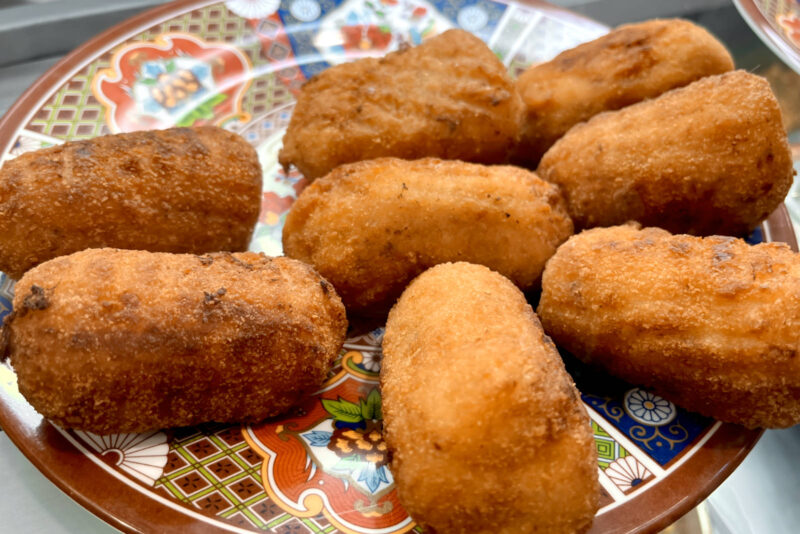 Spanish vegetarian tapas croquettes on a colorful plate